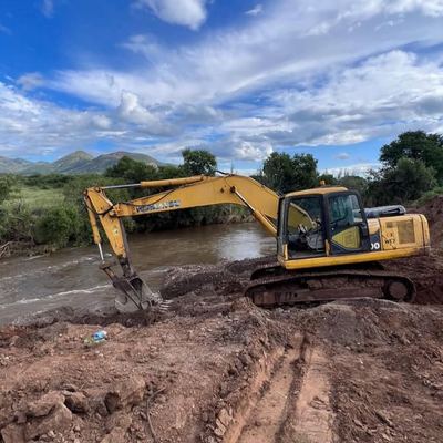 Excavator carrying out river-crossing earthworks