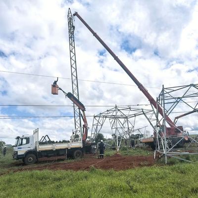 TMP crew with a cherry-picker and crane erecting a power pylon